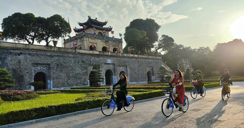Explore Thang Long Imperial Citadel by bicycle in traditional Ao Dai